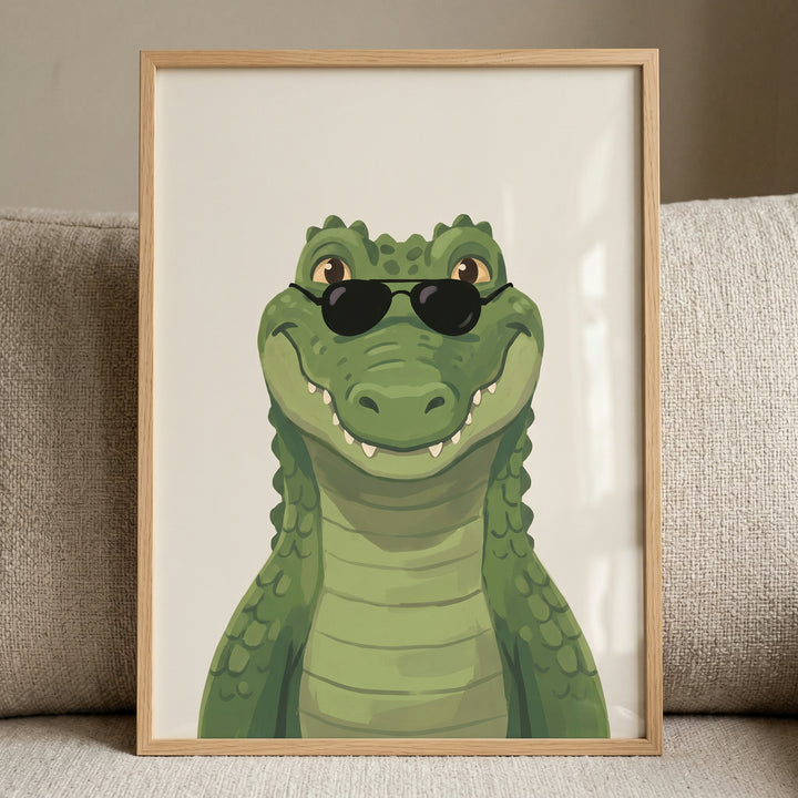 Cool sunglasses crocodile wall art featuring a smiling green cartoon reptile in a light wood frame.
