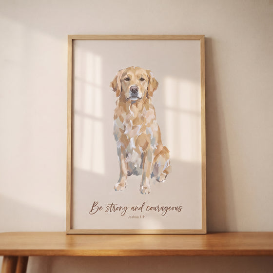 Framed courageous bible golden retriever wall art with a dog and Be strong and courageous Joshua 1:9 on a wooden table.