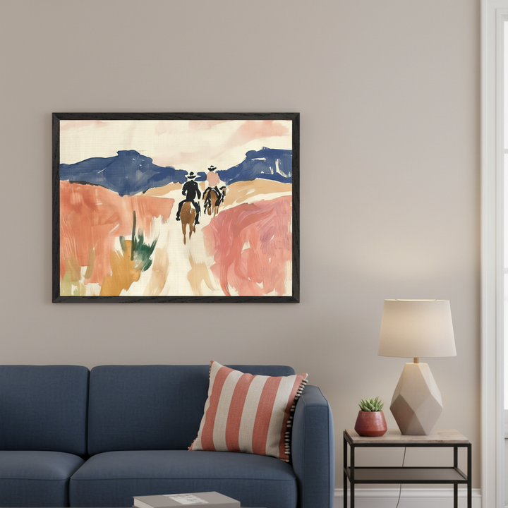 Modern living room with a blue sofa. A framed abstract painting depicts three figures on horseback riding through a desert landscape with blue mountains and coral-toned terrain. It hangs above the sofa.