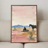 Watercolor painting of a cowboy sitting on a bedroll beside his horse in a desert landscape, with soft pink and orange tones in the sky and cacti dotting the foreground. A wisp of smoke rises above the cowboy, adding to the peaceful, western atmosphere.
