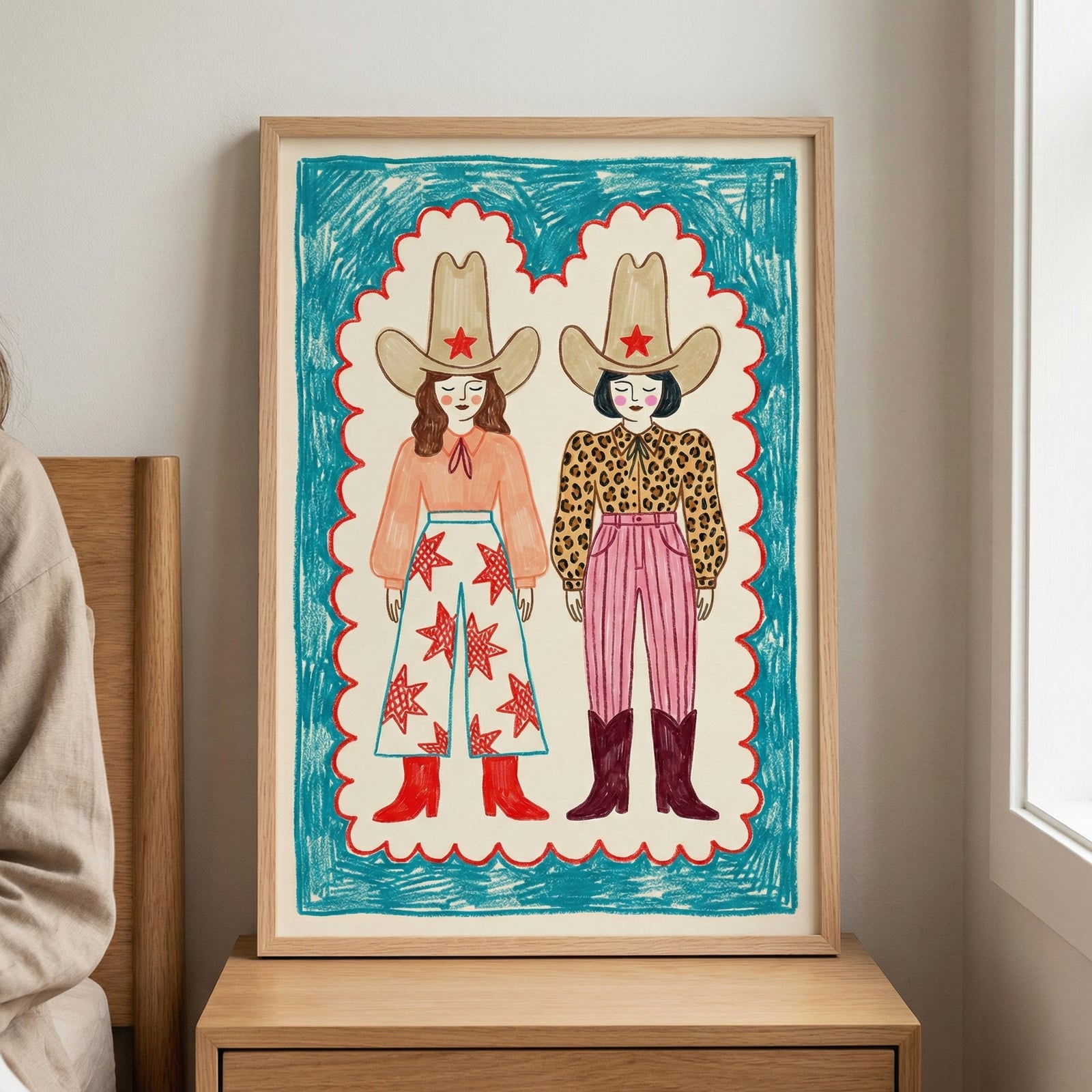 Colorful folk art-style illustration of two cowgirls wearing oversized hats with red stars, bold western outfits, and boots, framed with a bright blue and red border.