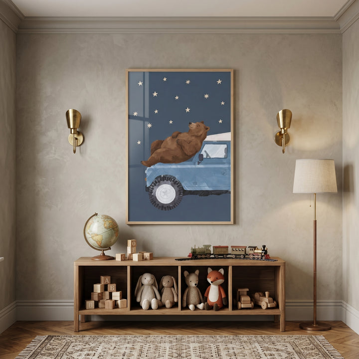 Cozy night sky bear wall art hangs above a toy shelf with stuffed animals, a globe, and blocks in a neutral nursery.