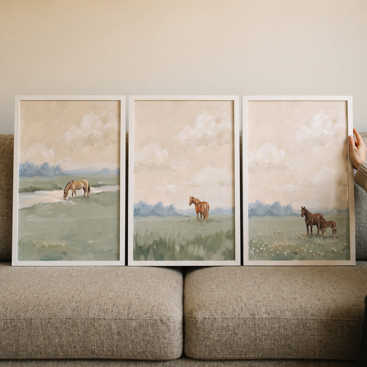 Creamy horizon pasture horse wall art set of 3 features horses grazing in soft green fields under a cloudy sky.