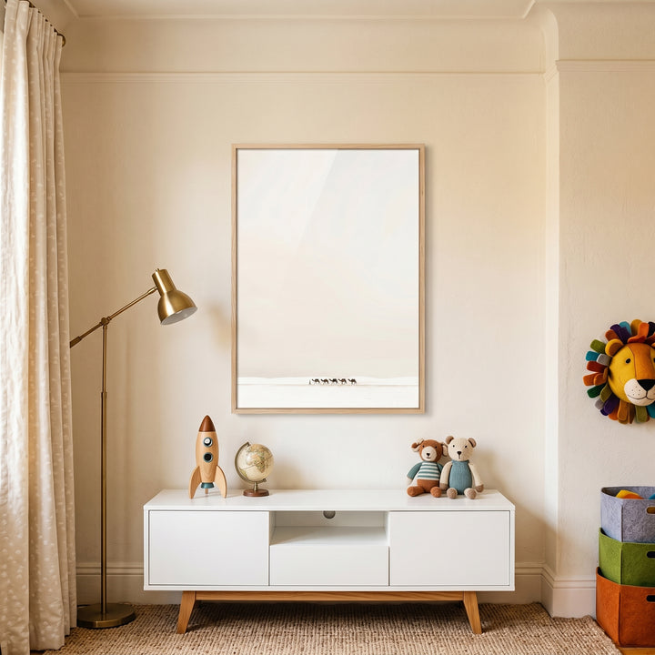 Creamy minimalist white camel wall art above a white cabinet with a toy rocket, globe, bears, and a gold floor lamp.