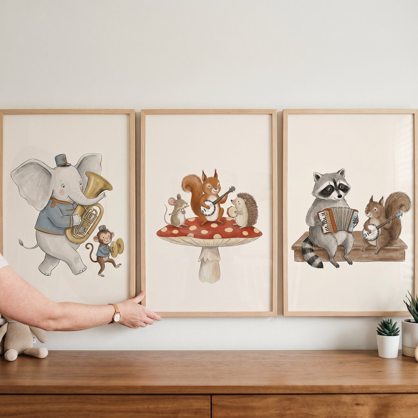 Creamy neutral animal band print set of 3 featuring an elephant, raccoon, and squirrels playing musical instruments.