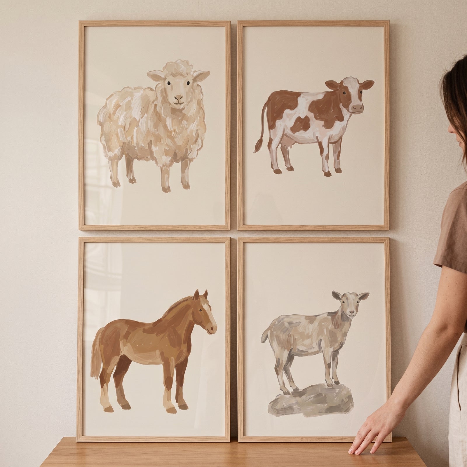 Creamy tan farm animals wall art set of 4 featuring a sheep, cow, horse, and goat in light wood frames.