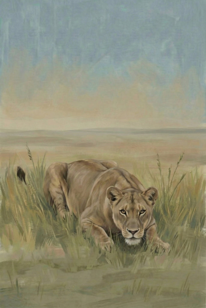 A lioness lies low in tall grass, her body poised and eyes fixed forward in an alert, focused gaze. The background features a vast, muted savanna under a soft blue sky.

