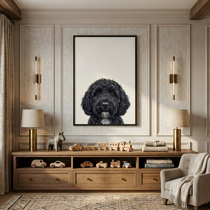 Curly black doodle dog wall art hangs above a wooden console with toys and lamps in a neutral room.