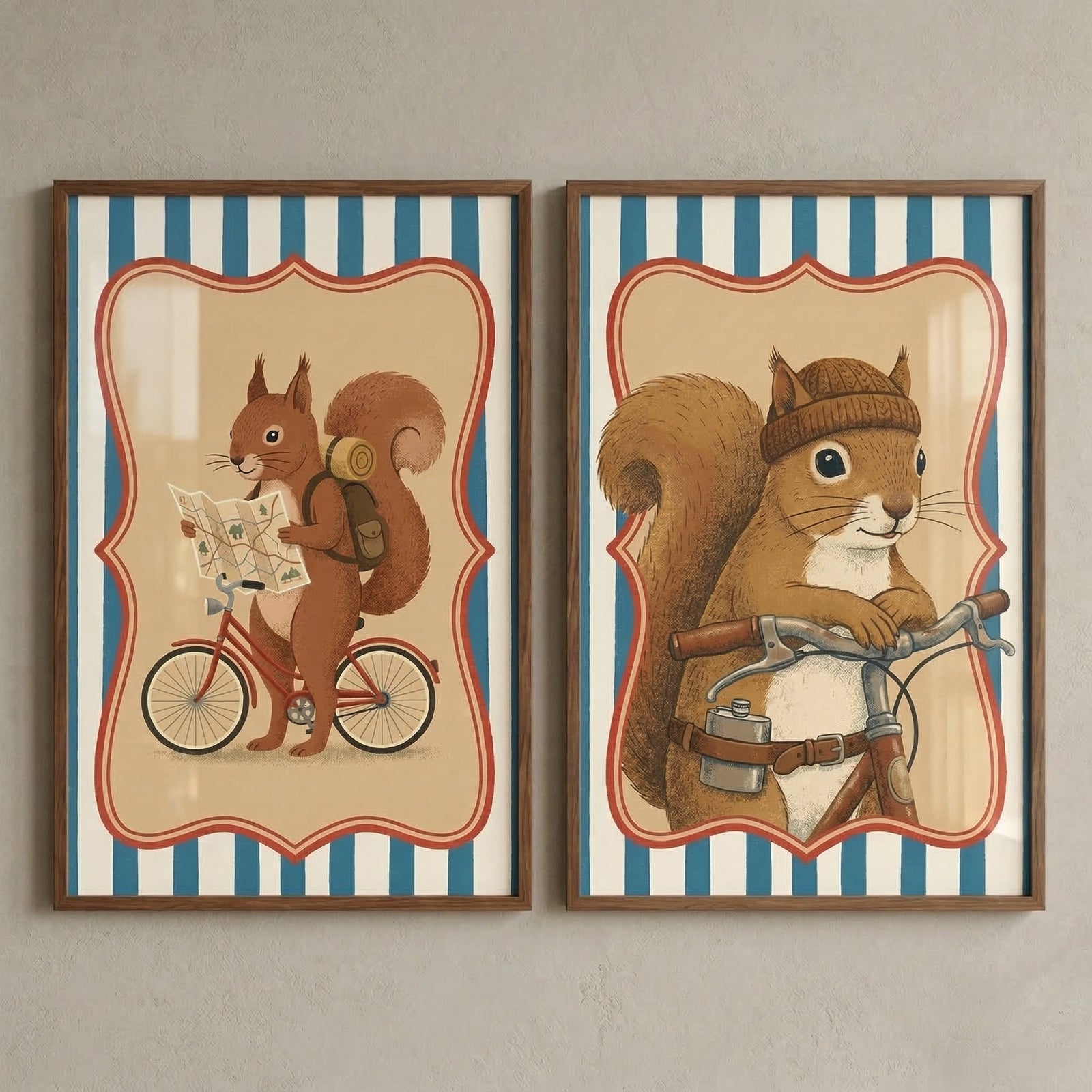 Two side-by-side framed illustrations of a squirrel in matching dark wood frames against a neutral wall. Both pieces feature vertical blue and white stripes behind a cream-colored, red-bordered scalloped shape. The left illustration shows a brown squirrel riding a red bicycle while carrying a backpack and studying an open map. The right illustration is a portrait of the squirrel wearing a knit beanie and leaning on bicycle handlebars, with a small metal flask on its belt.