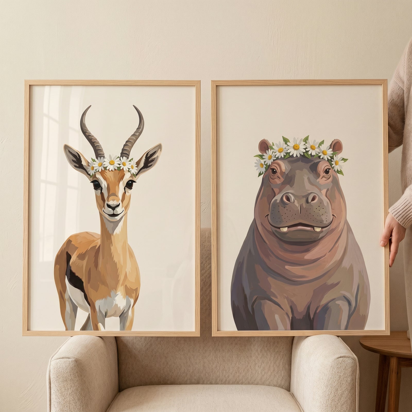 Framed gazelle and hippo prints in daisy crown safari animals wall art set of 2 resting on a neutral armchair.