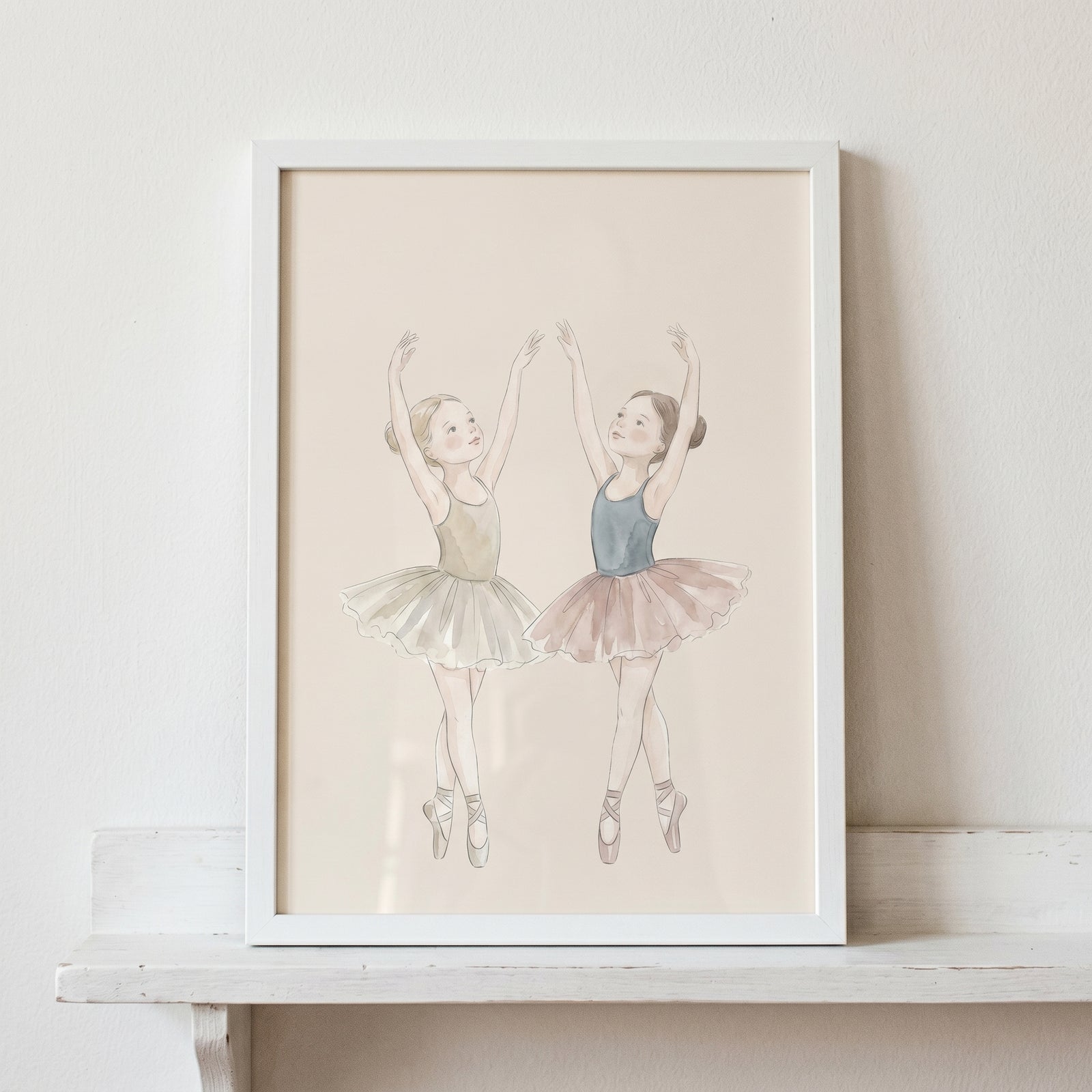 Two young ballerinas in tutus pose in this dancing watercolor girls ballerina wall art displayed in a white frame.