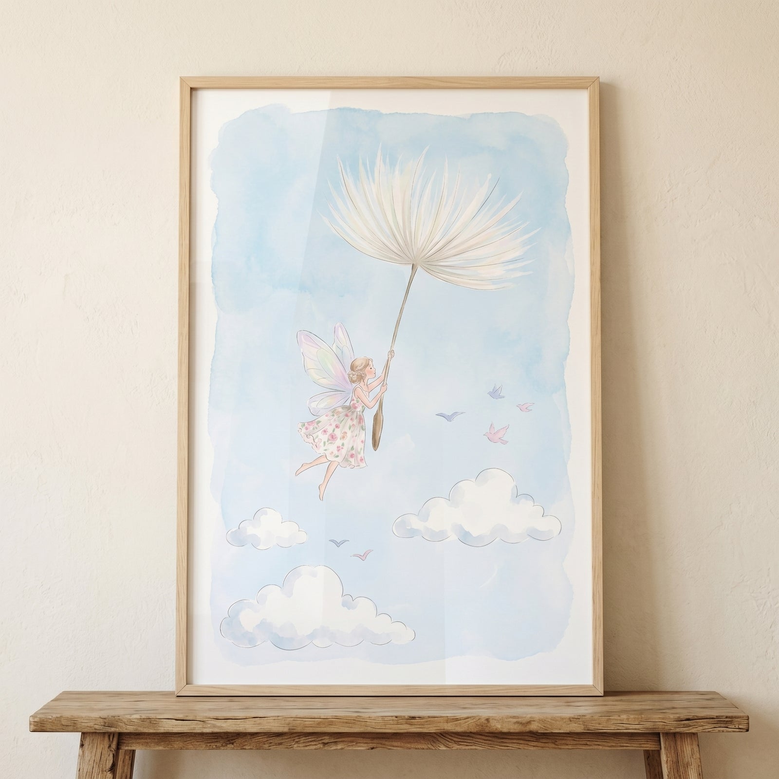 Framed dandelion puff flying fairy wall art featuring a fairy floating in a soft blue sky with white clouds and birds.