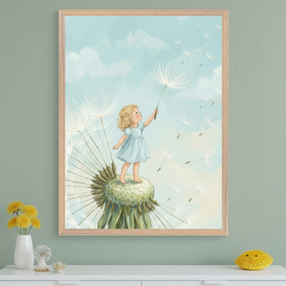 Modern room with a sage green wall. A large framed illustration of a blonde child in a blue dress standing on a dandelion head, holding one seed as others drift in a blue sky, hangs centered above a white dresser. Yellow flowers and a fluffy toy are on the dresser.