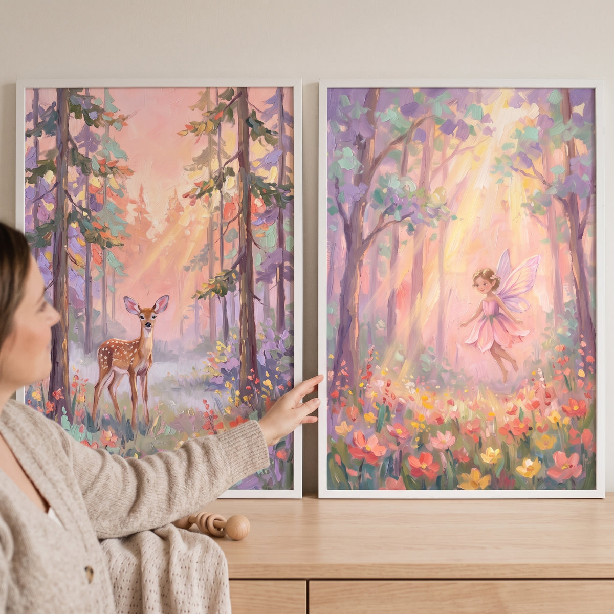 A woman touches a dappled sunlit woodland wall art set of 2 featuring a fawn and a winged fairy in a soft forest.