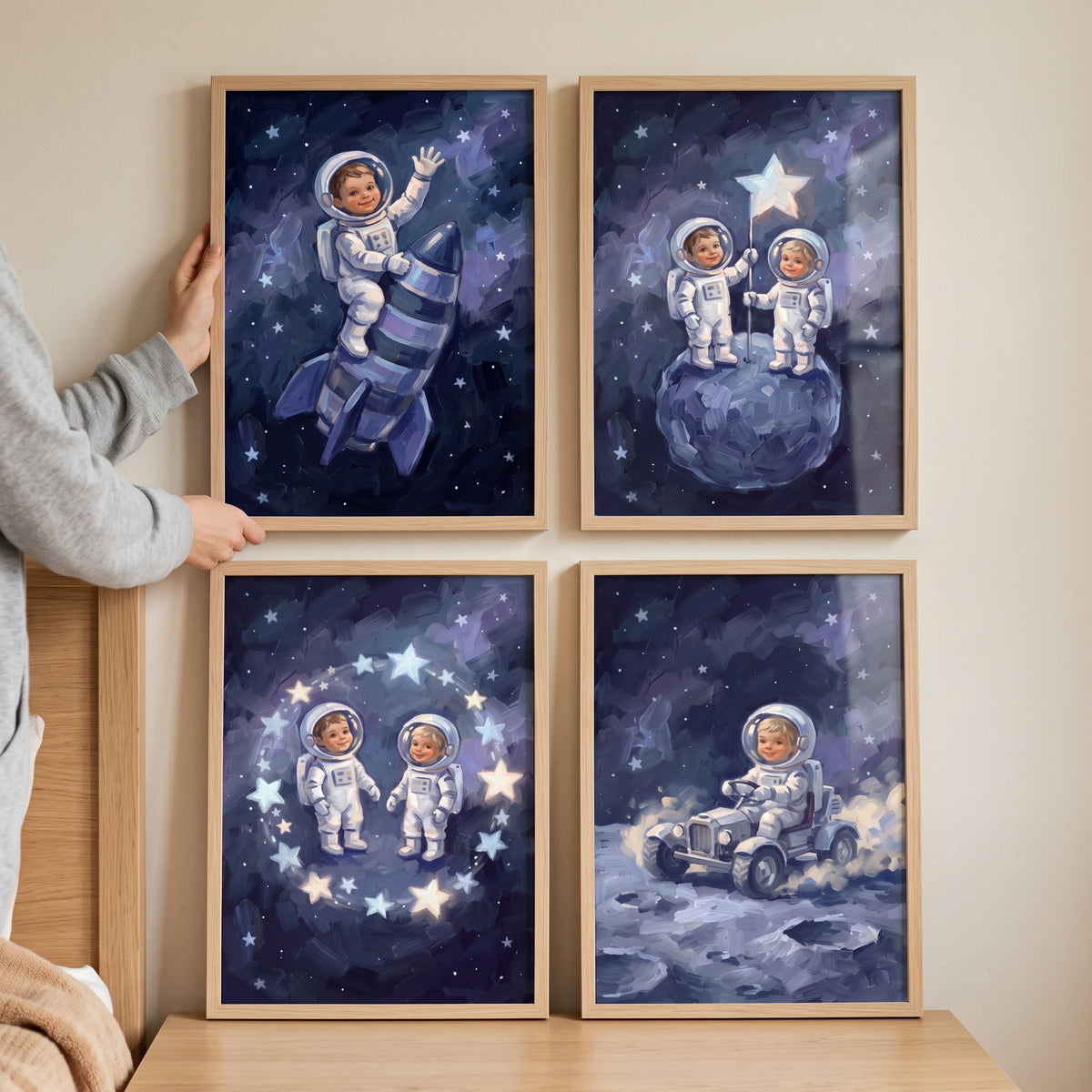 Dark indigo little astronaut wall art set of 4 shows children in space suits with a rocket, moon rover, and glowing stars.