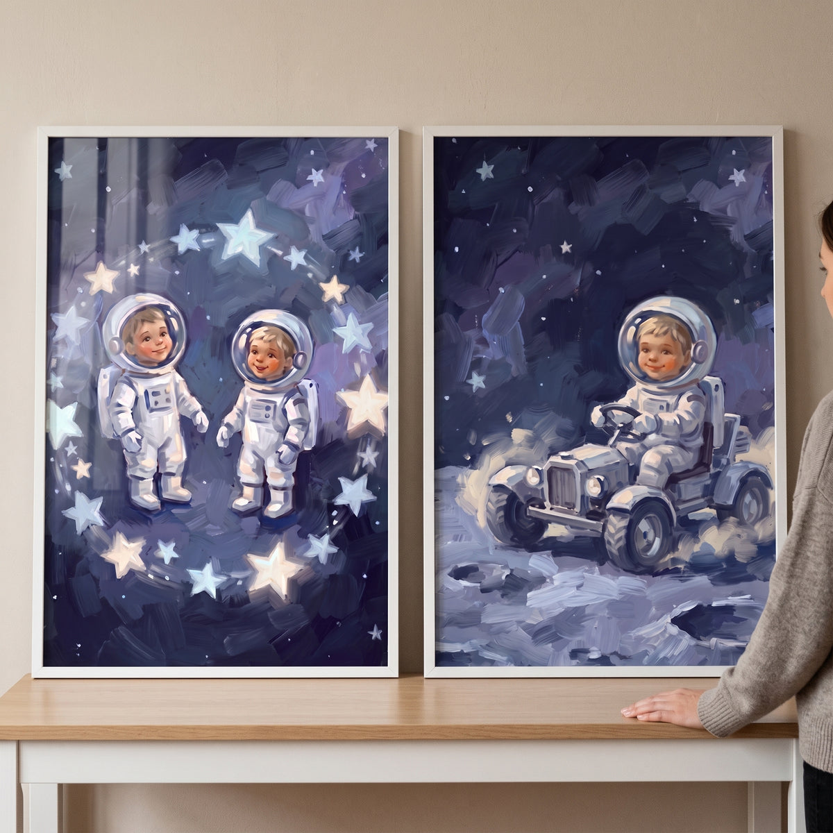 Dark stellar baby astronaut wall art set of 2 features toddlers in space suits among stars and driving a moon rover.