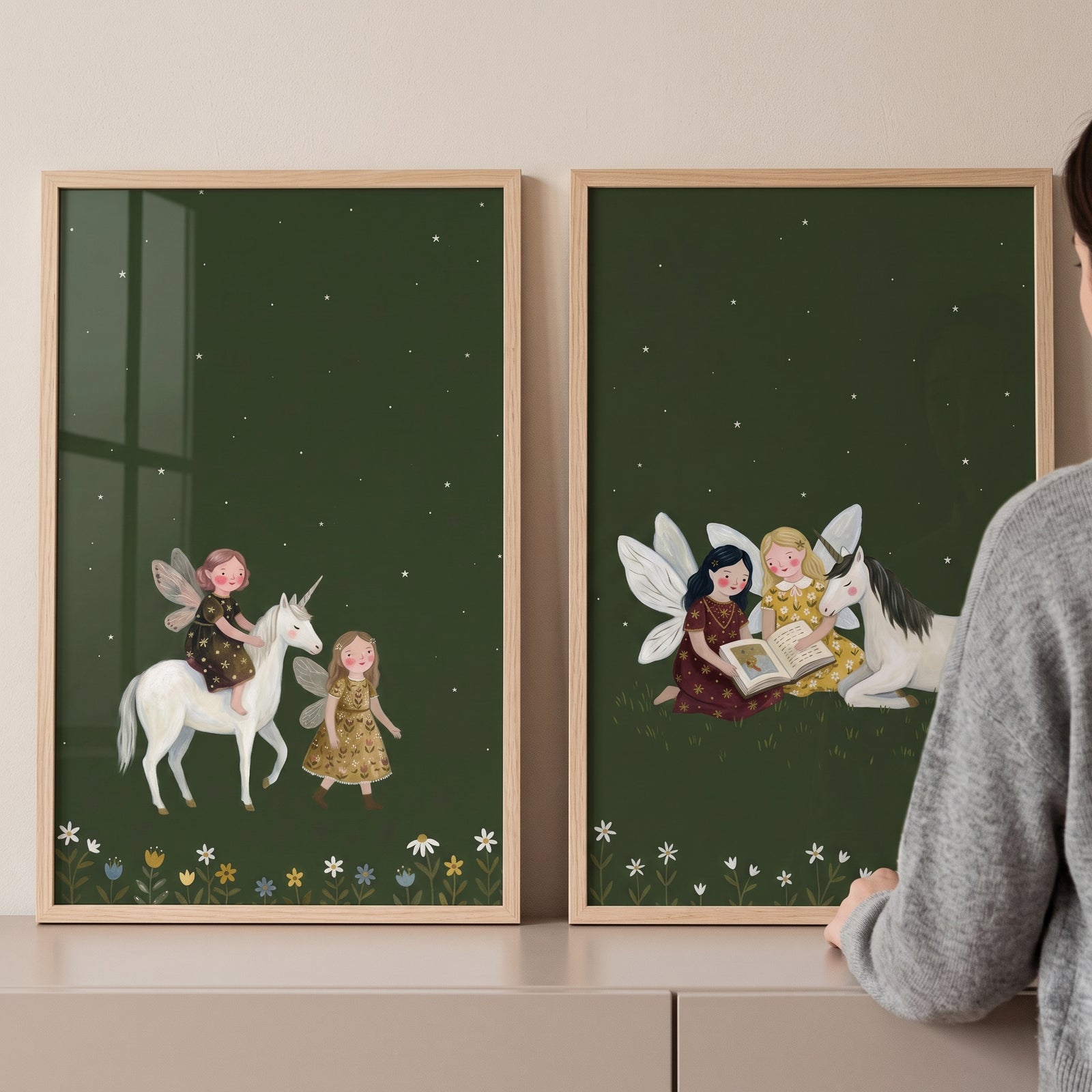 Deep green fairies wall art set of 2 features fairies and white unicorns under a starry sky and above wildflowers.