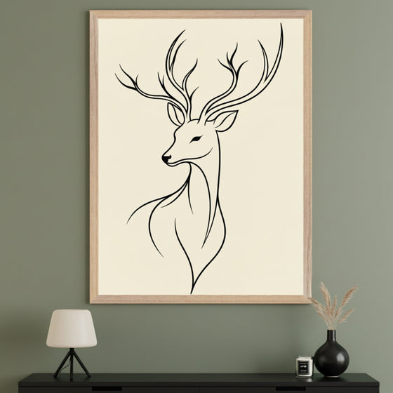 Modern living room with a large framed minimal line art drawing of a deer with antlers on a cream background, centered above a black credenza. A white lamp is on the left; a black vase with dried grasses and a candle are on the right.