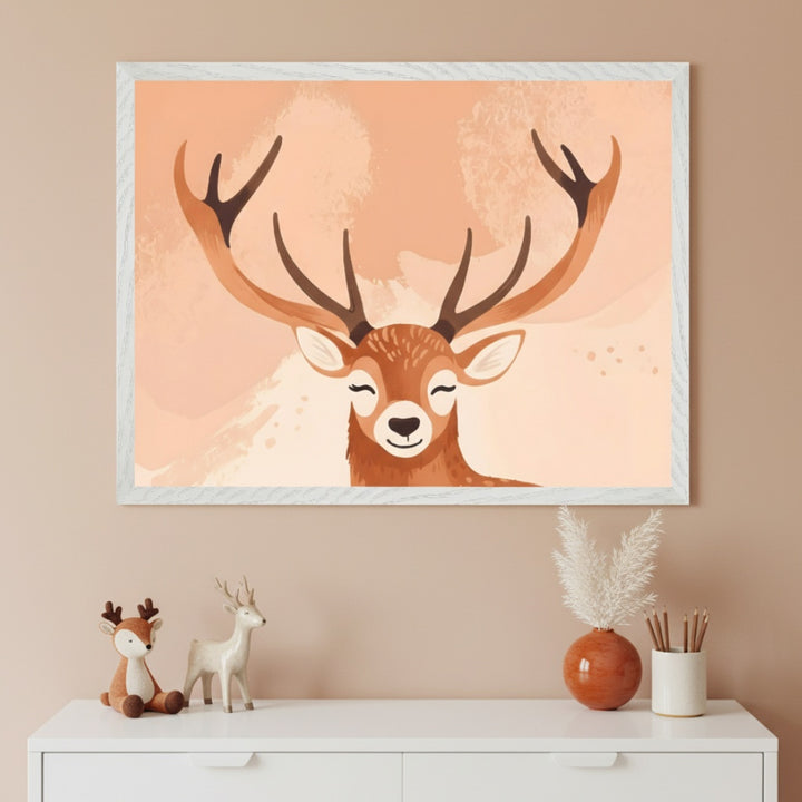 A stylized illustration of a smiling deer with large antlers set against a peach-toned abstract background. The art is displayed above a dresser with deer figurines and soft neutral decor, creating a cozy woodland vibe.