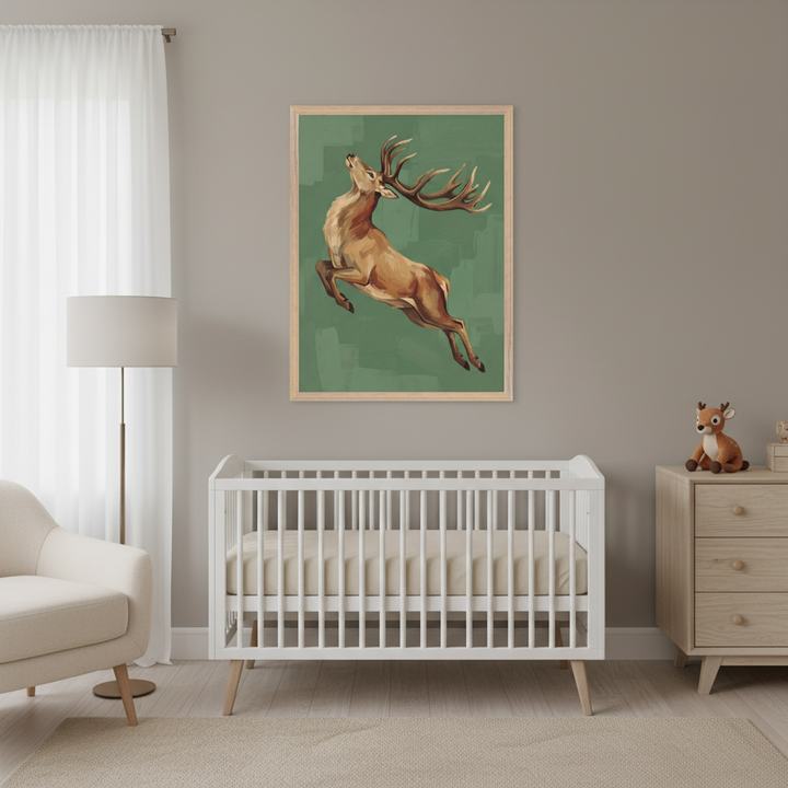 Modern nursery with a white crib, cream armchair, and wooden dresser. A large framed painting of a leaping brown deer on a green background hangs above the crib on a gray wall.