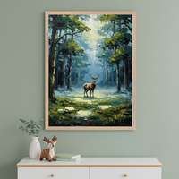 Framed artwork of a majestic stag standing in a sunlit clearing within a dense forest, with bold brushstrokes and deep greens and blues. The artwork hangs above a white dresser decorated with a plush deer toy, books, and a vase with eucalyptus branches.