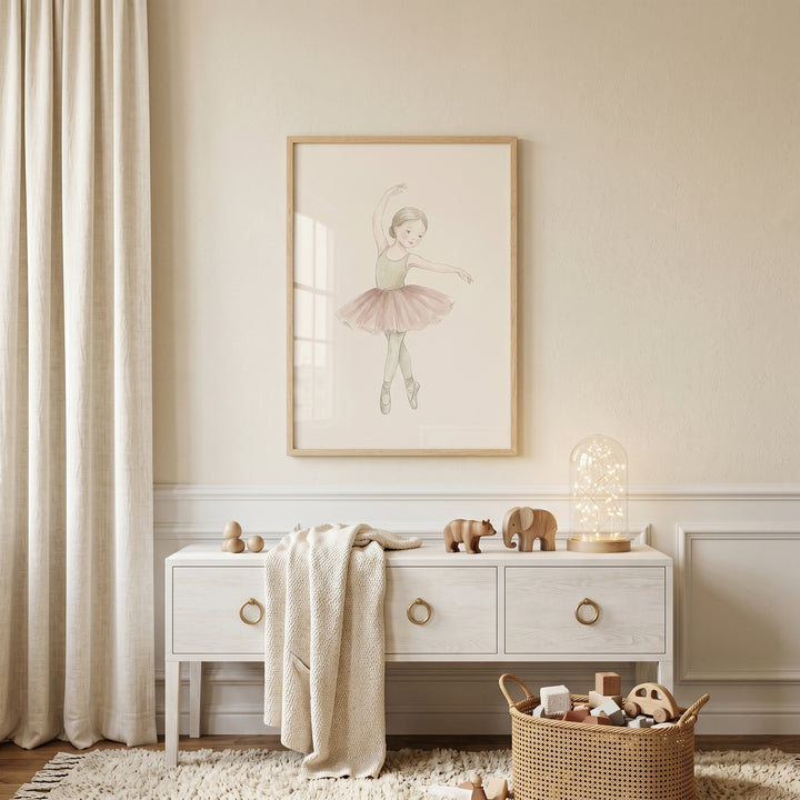 Delicate beige leotard ballerina wall art above a white dresser with wooden animals, a soft blanket, and a toy basket.