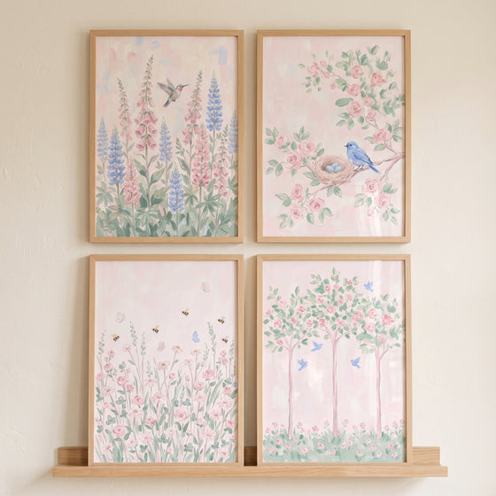 Delicate blush botanical garden wall art set of 4 with birds, bees, and flowers in light wood frames.