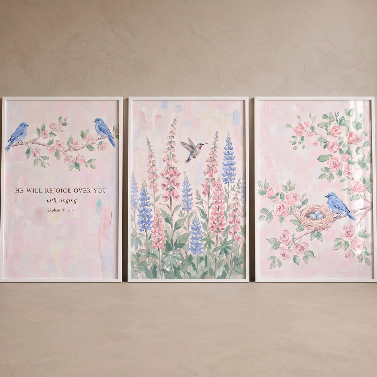 Delicate pastel floral bird wall art set of 3 featuring blue birds, a hummingbird, and Zephaniah 3:17 on pink backgrounds.