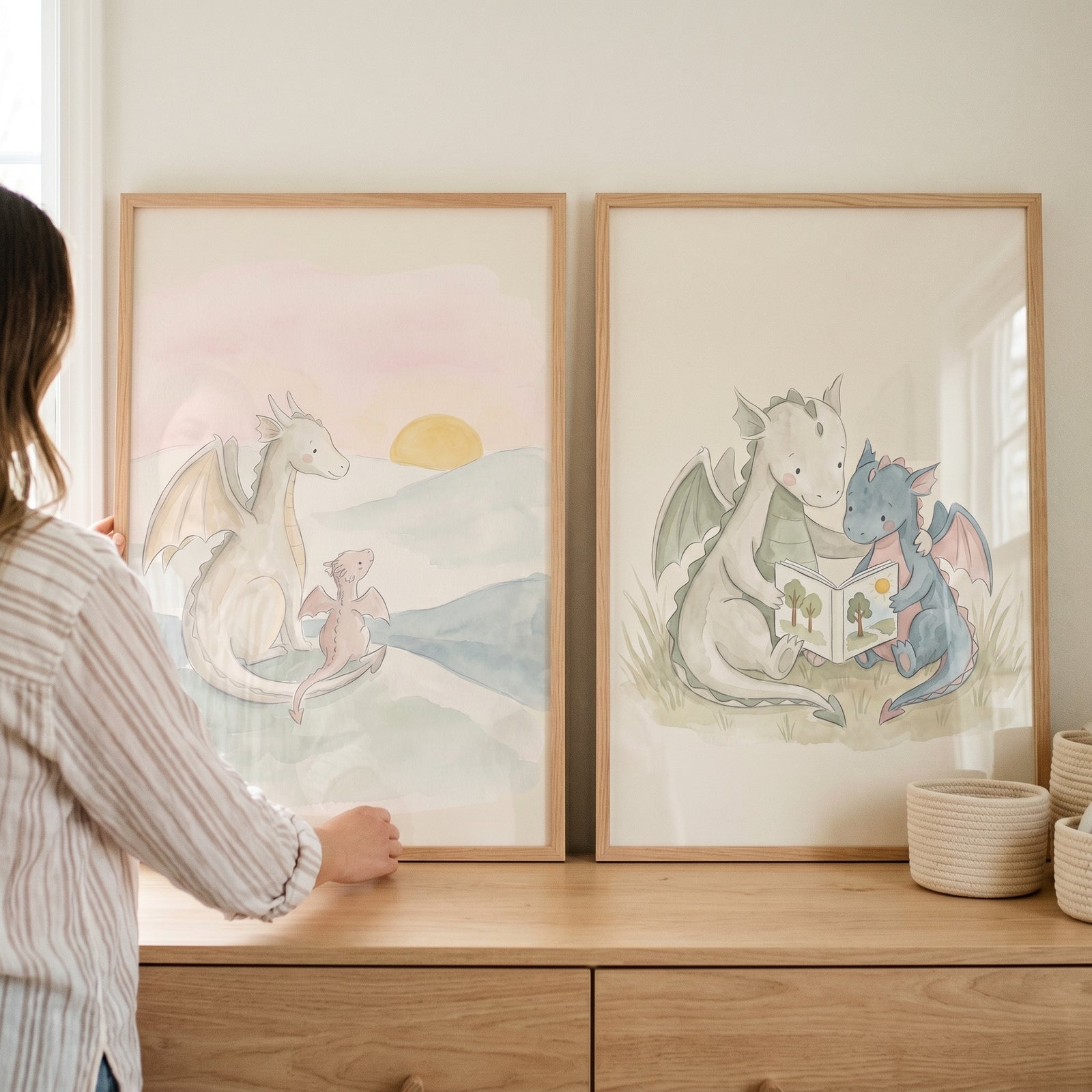 delicate watercolor baby dragons wall art set of 2 with white, pink, and blue dragons at sunset and reading a book.