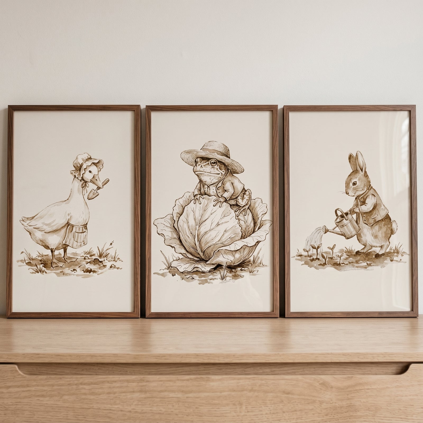 Detailed sketch garden animal wall art set of 3 features a duck, frog, and rabbit in sepia-toned gardening scenes.