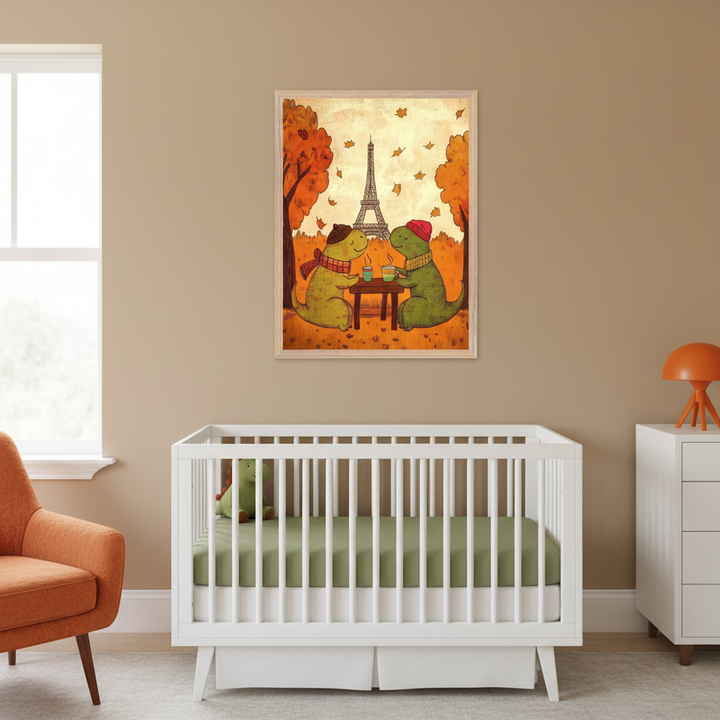 Modern nursery with a white crib, an orange armchair, and a white dresser. A framed print hangs above the crib, depicting two cartoon dinosaurs in autumn attire drinking coffee at a table in Paris, with the Eiffel Tower and falling leaves.