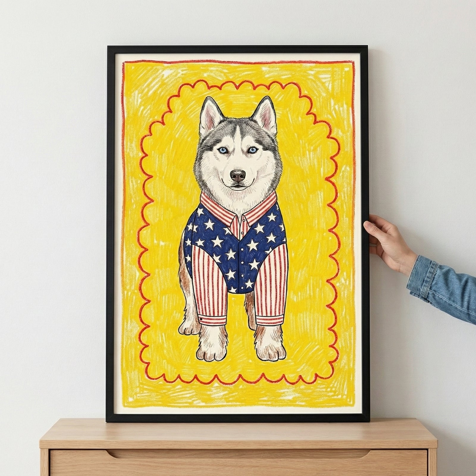 A whimsical, child-like illustration of a blue-eyed husky wearing a patriotic stars-and-stripes vest, centered within a scalloped red border on a vibrant yellow textured background.