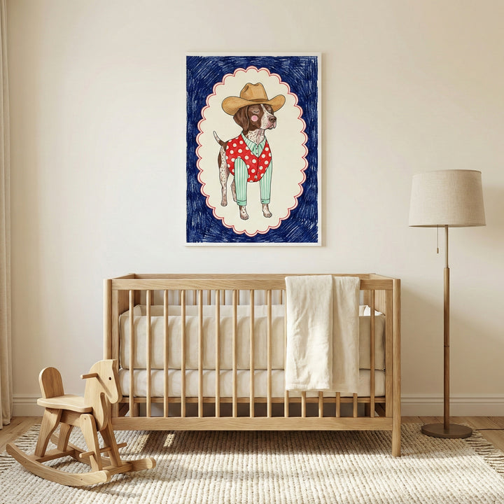 Framed illustration of a dog dressed as a cowboy, wearing a tan hat, green striped shirt, and red polka-dotted vest, hanging on the wall above a wooden crib in a cozy, neutral-toned nursery. The nursery also features a floor lamp, a light rug, and a wooden rocking horse. The dog portrait has a whimsical, playful style, outlined by a scalloped frame with a dark blue background.