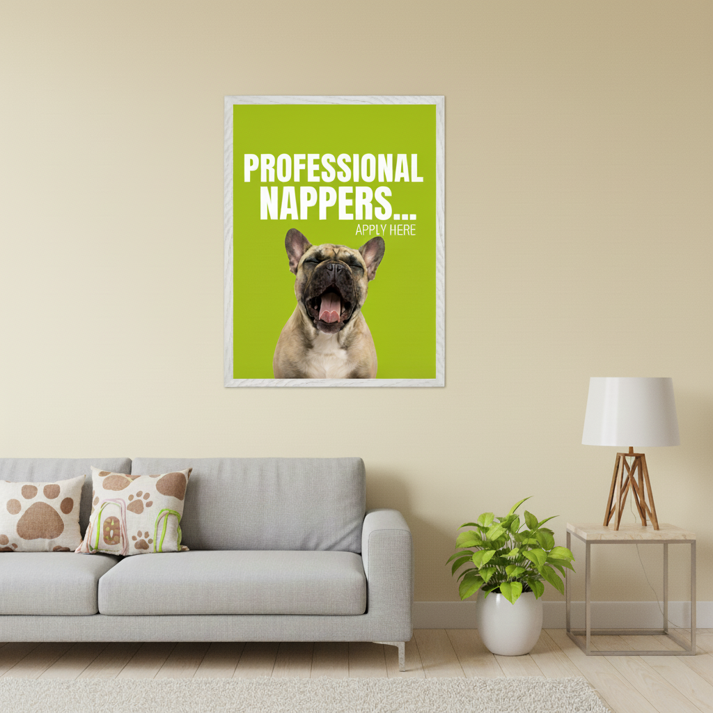 Modern living room with a gray sofa. A framed, bright green poster hangs above the sofa, featuring text "PROFESSIONAL NAPPERS... APPLY HERE" and a yawning French bulldog.