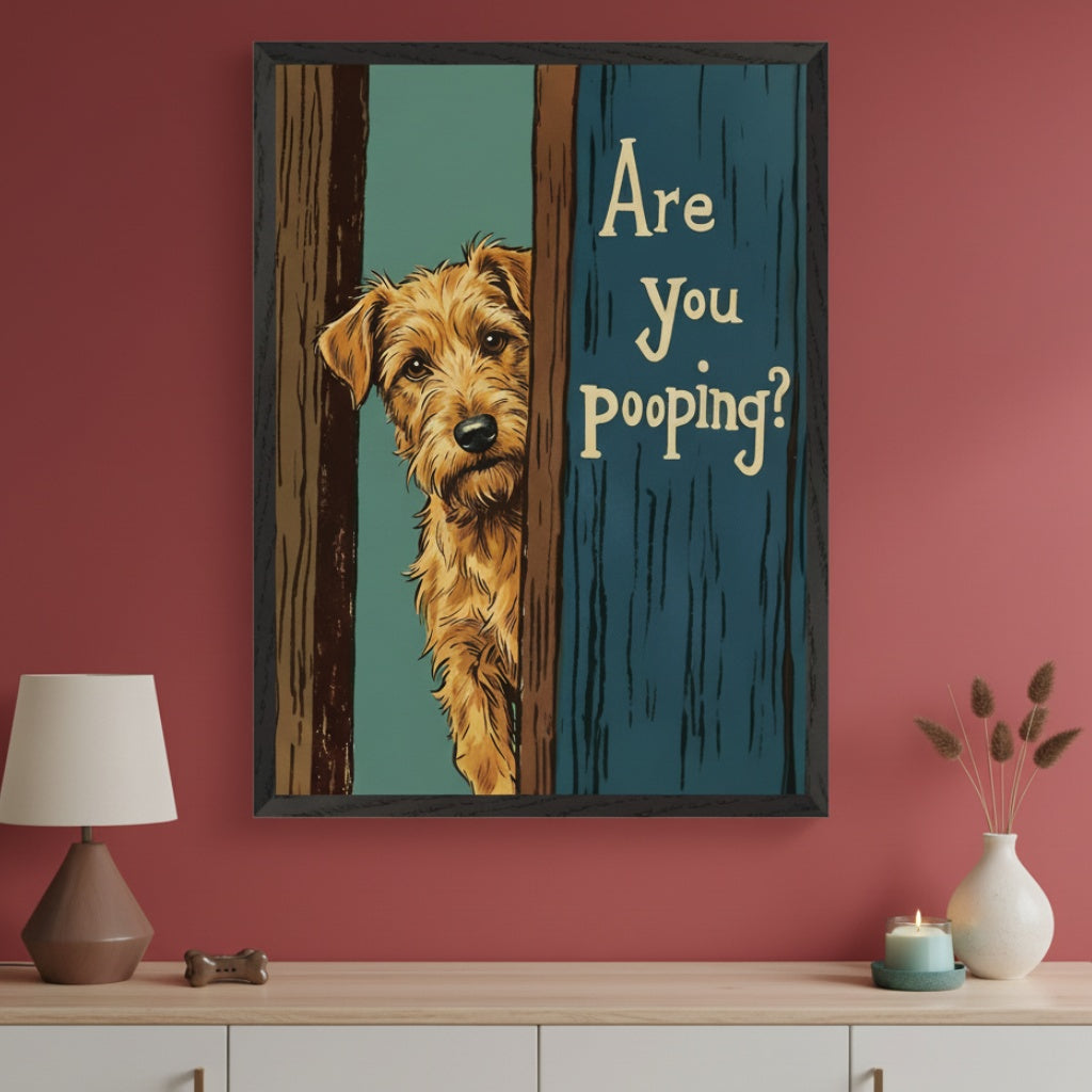 Modern room with a rust-colored wall. A black-framed, illustrative print of a brown dog peeking from a doorway, with "Are You Pooping?" text, hangs above a light wood console table.