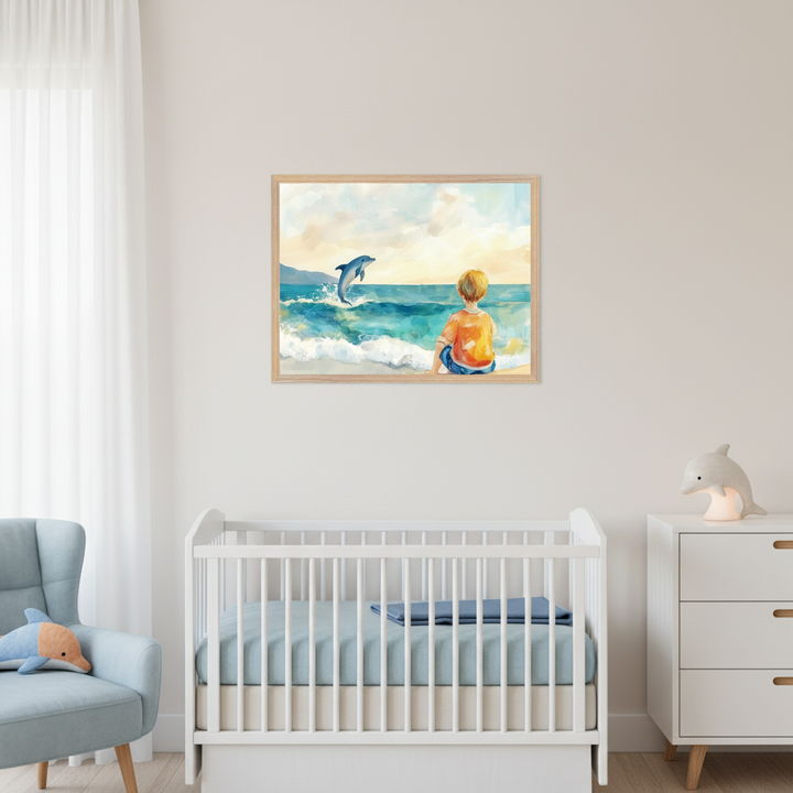 Modern nursery with a white crib, light blue armchair, and white dresser. A framed watercolor painting of a boy watching a dolphin jump at sunset on a beach hangs above the crib.