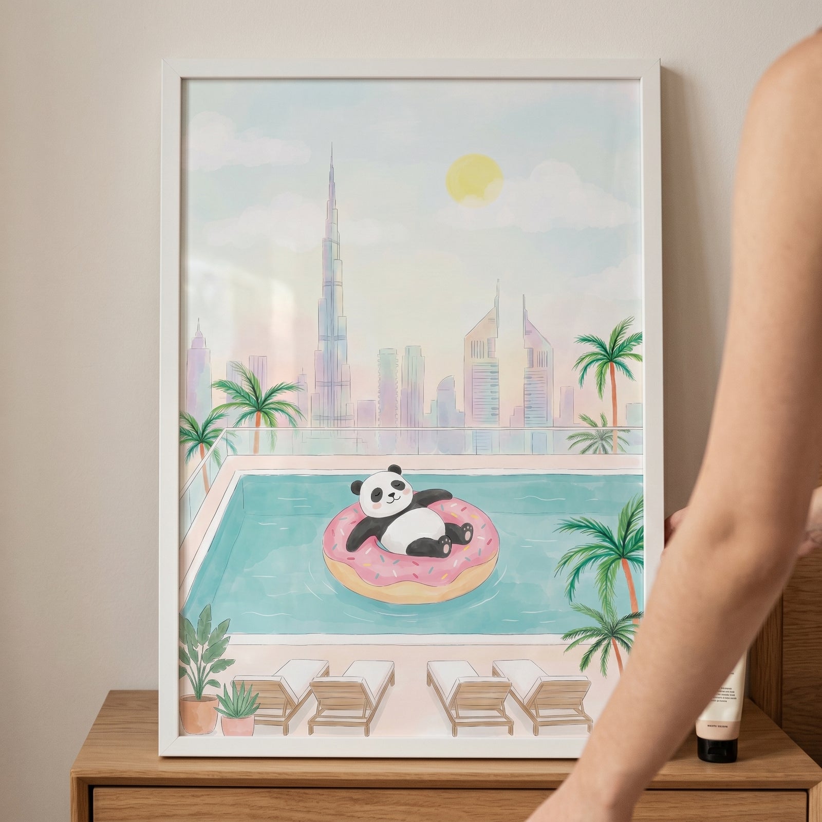 Framed donut float panda wall art shows a cartoon panda in a swimming pool with a skyscraper city skyline and palm trees.