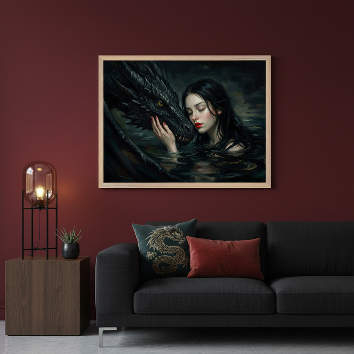 Modern living room with deep red walls. Centered above a dark gray sofa, a light wooden framed, dark fantasy style print shows a woman in dark water gently touching a black dragon's face. A wooden side table with a lamp is to the left.