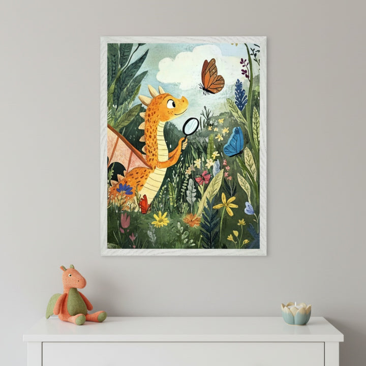 Kid's room with a white dresser. Above it, a framed illustration shows an orange dragon with a magnifying glass examining butterflies in a vibrant, flowery garden. A plush dragon toy and a decorative candle sit on the dresser.