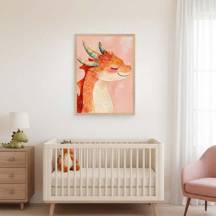 Modern nursery with a light wood crib, dresser, and pink armchair. A framed watercolor illustration of an orange, sleepy-eyed dragon with green horns hangs above the crib.