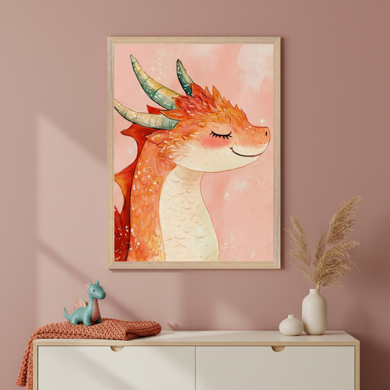 Modern kid's room with a pink wall and white dresser. A framed watercolor illustration of a smiling orange dragon with green horns hangs above the dresser. A blue dinosaur toy, orange blanket, and two white vases with dried pampas grass are on the dresser.