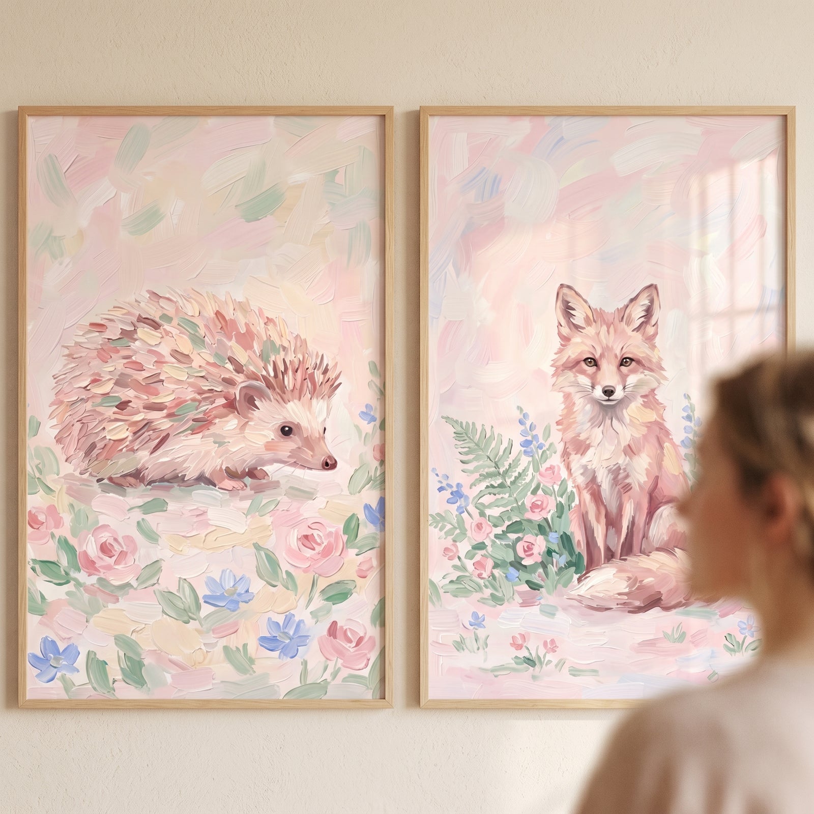 Dreamy blush woodland animals wall art set of 2 featuring a textured hedgehog and fox in soft pastel floral fields.