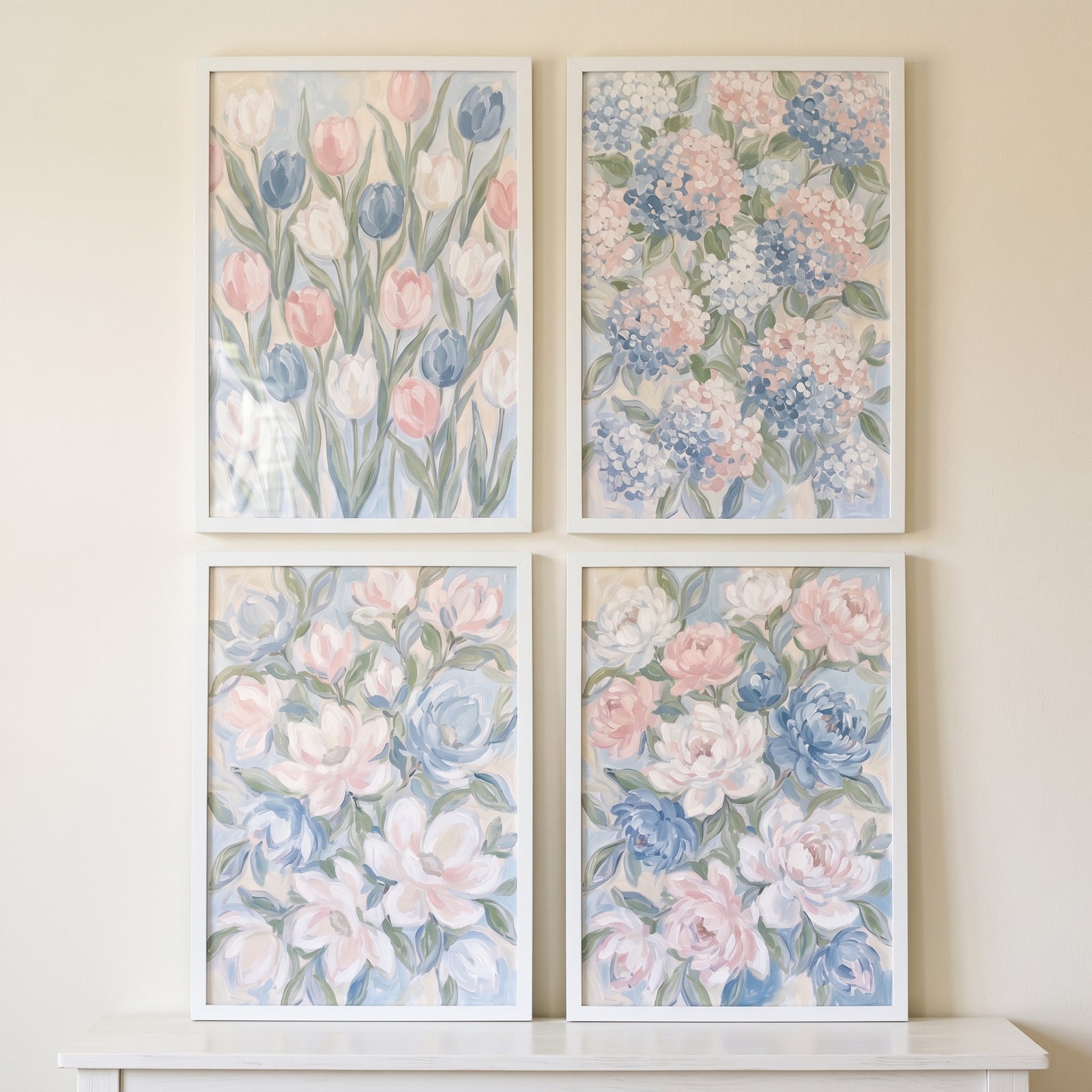 Dreamy dusty blue floral wall art set of 4 displays soft pink and blue blossoms in white frames on a neutral wall.