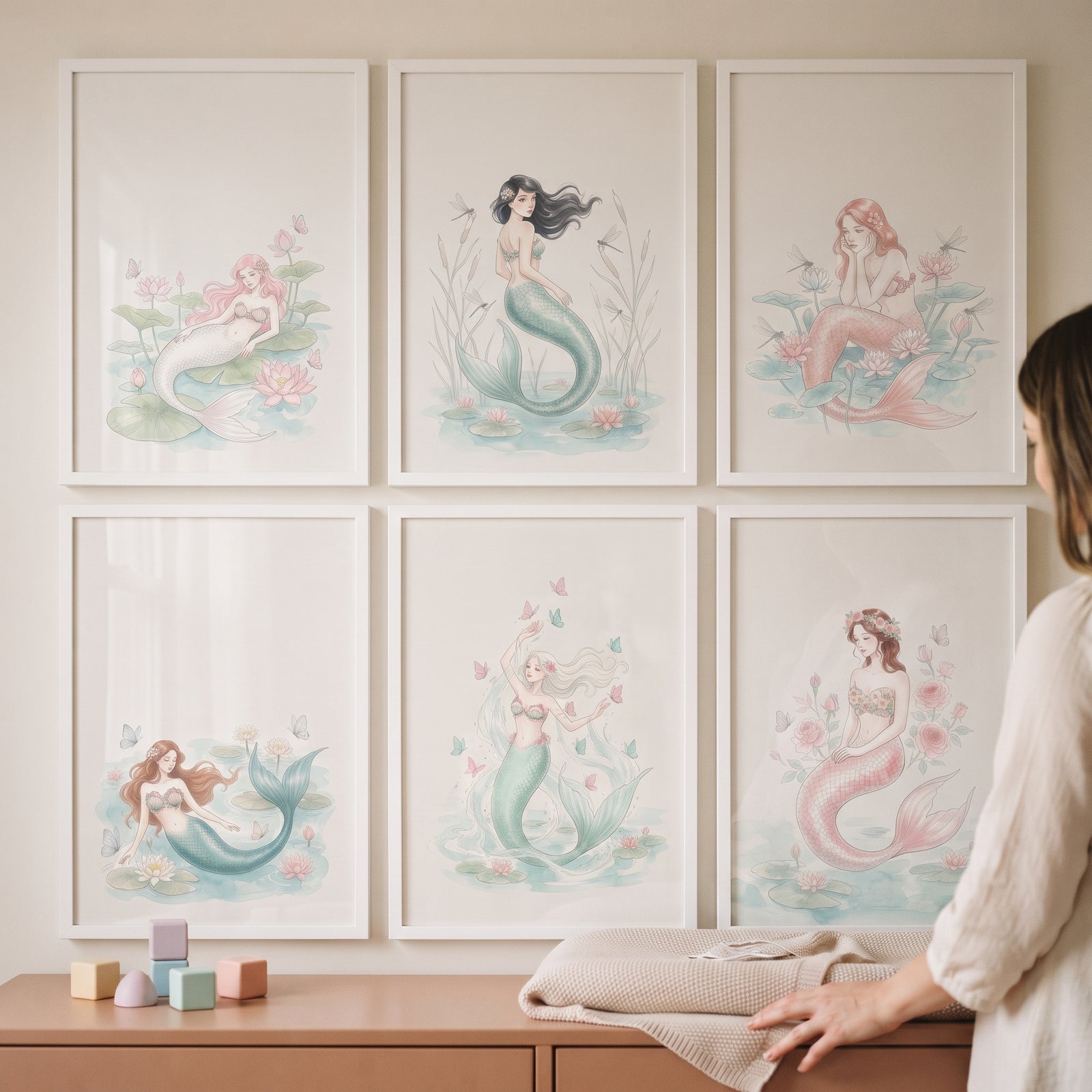 Dreamy ethereal pastel mermaid wall art set of 6 framed above a dresser with colorful blocks.