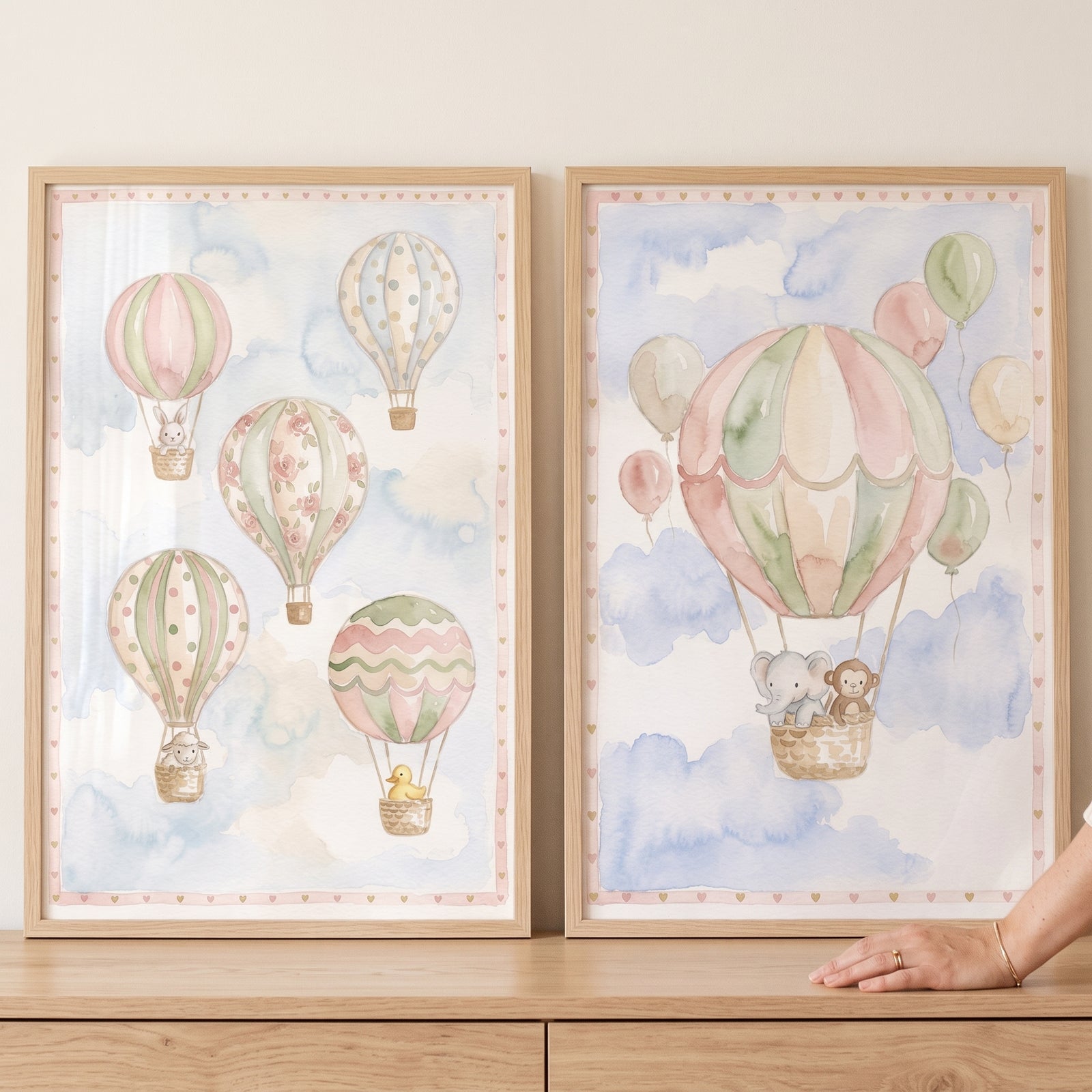 Dreamy hot air balloon wall art set of 2 with pastel watercolor balloons, clouds, and animals in light wood frames.