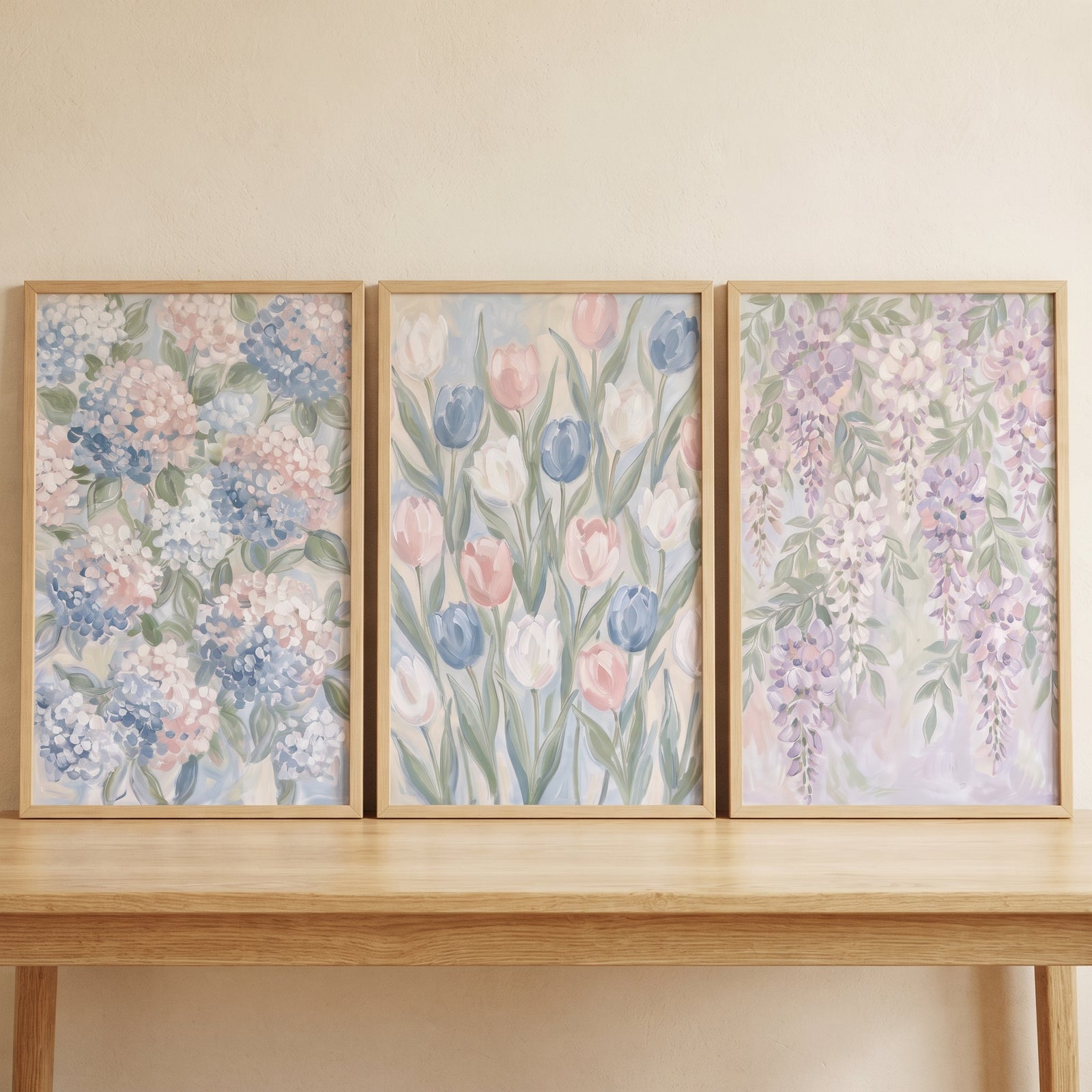 Dreamy impressionist garden floral wall art set of 3 with hydrangeas, tulips, and wisteria resting on a wooden table.