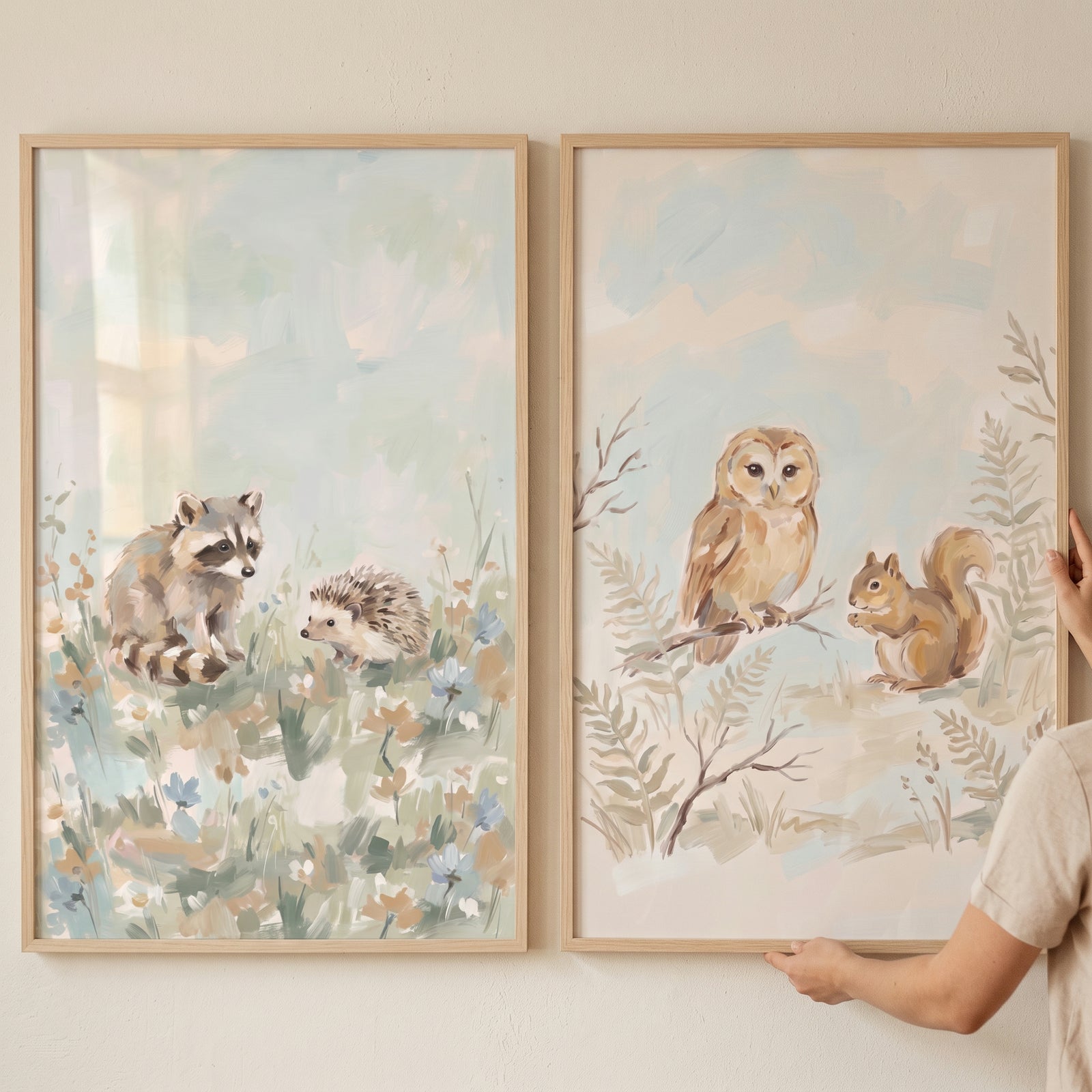 Dreamy pastel forest animals wall art set of 2 featuring a raccoon, hedgehog, owl, and squirrel in wooden frames.