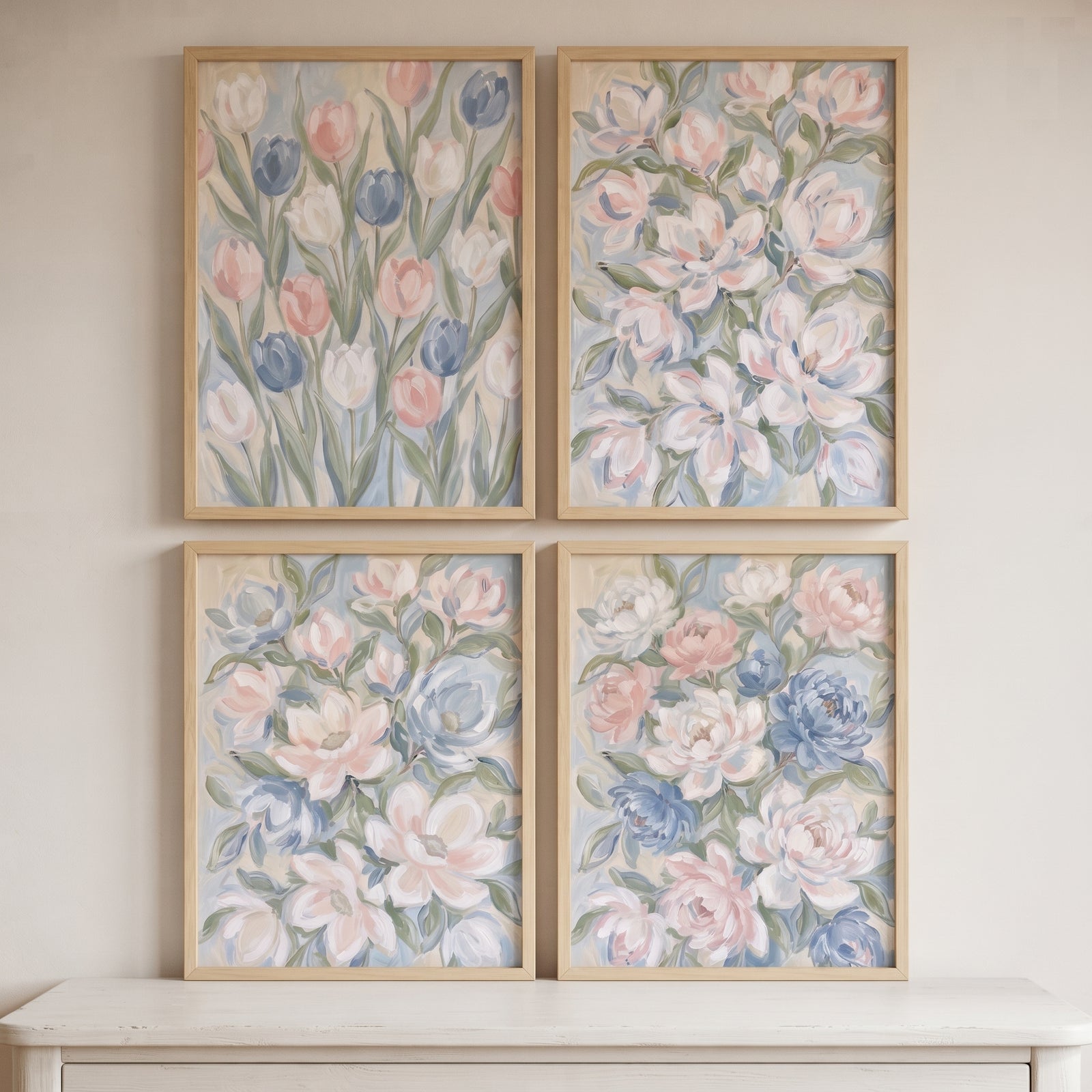 A dreamy pastel spring floral wall art set of 4 in light wood frames hung in a grid above a white dresser.