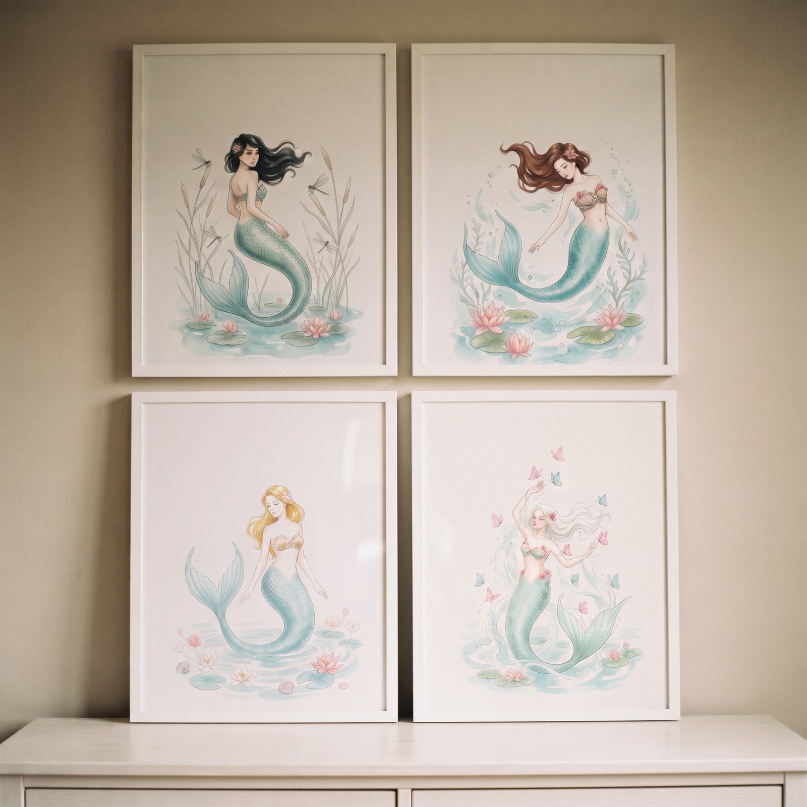 Dreamy pastel watercolor mermaid wall art set of 4 displayed in white frames on a neutral wall above a dresser.