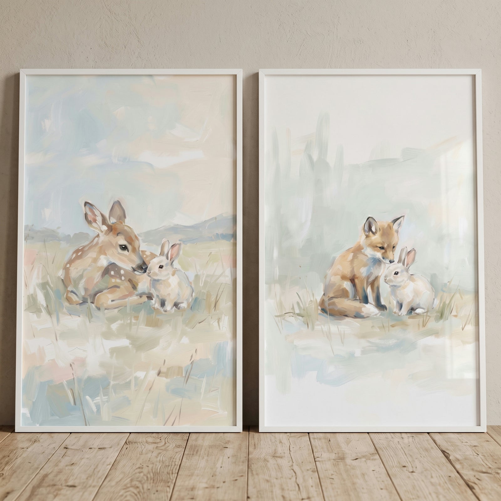 Dreamy pastel woodland animals wall art set of 2 featuring a fawn with a bunny and a fox with a bunny in white frames.